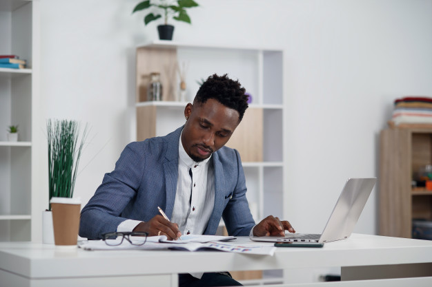 businessman with laptop young african businessman is typing something laptop his office 141188 5078